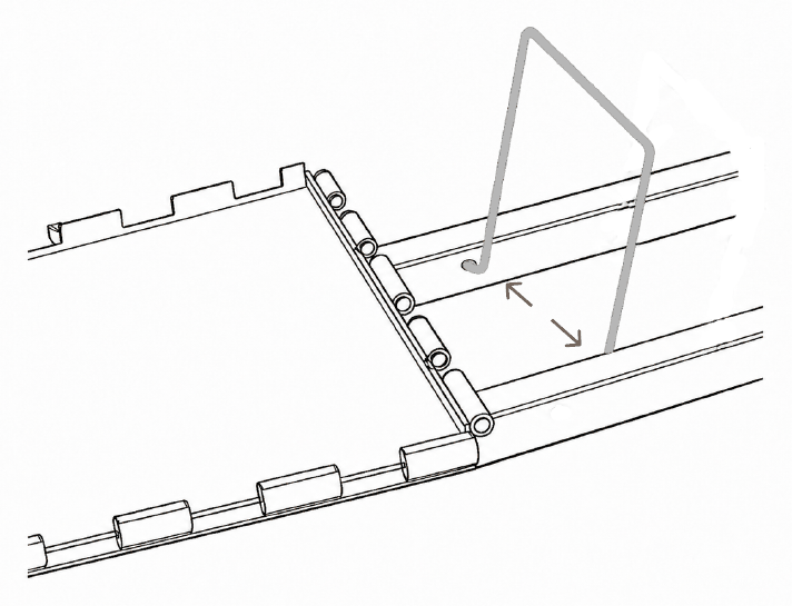 The U-shaped retaining bracket dropping between the frame rails, bent ends entering the holes in the inner faces