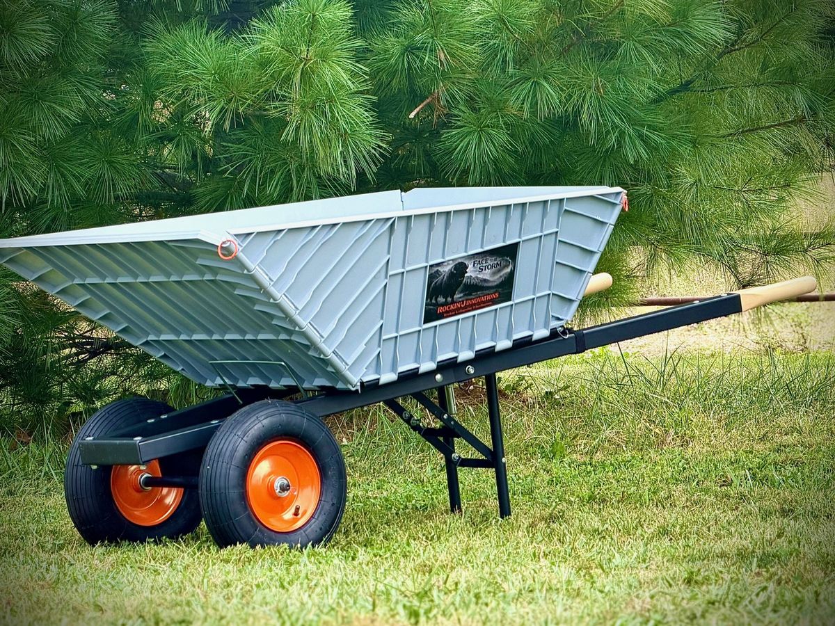 The finished wheelbarrow: poly tub, steel frame, wood-grip handles and dual pneumatic wheels