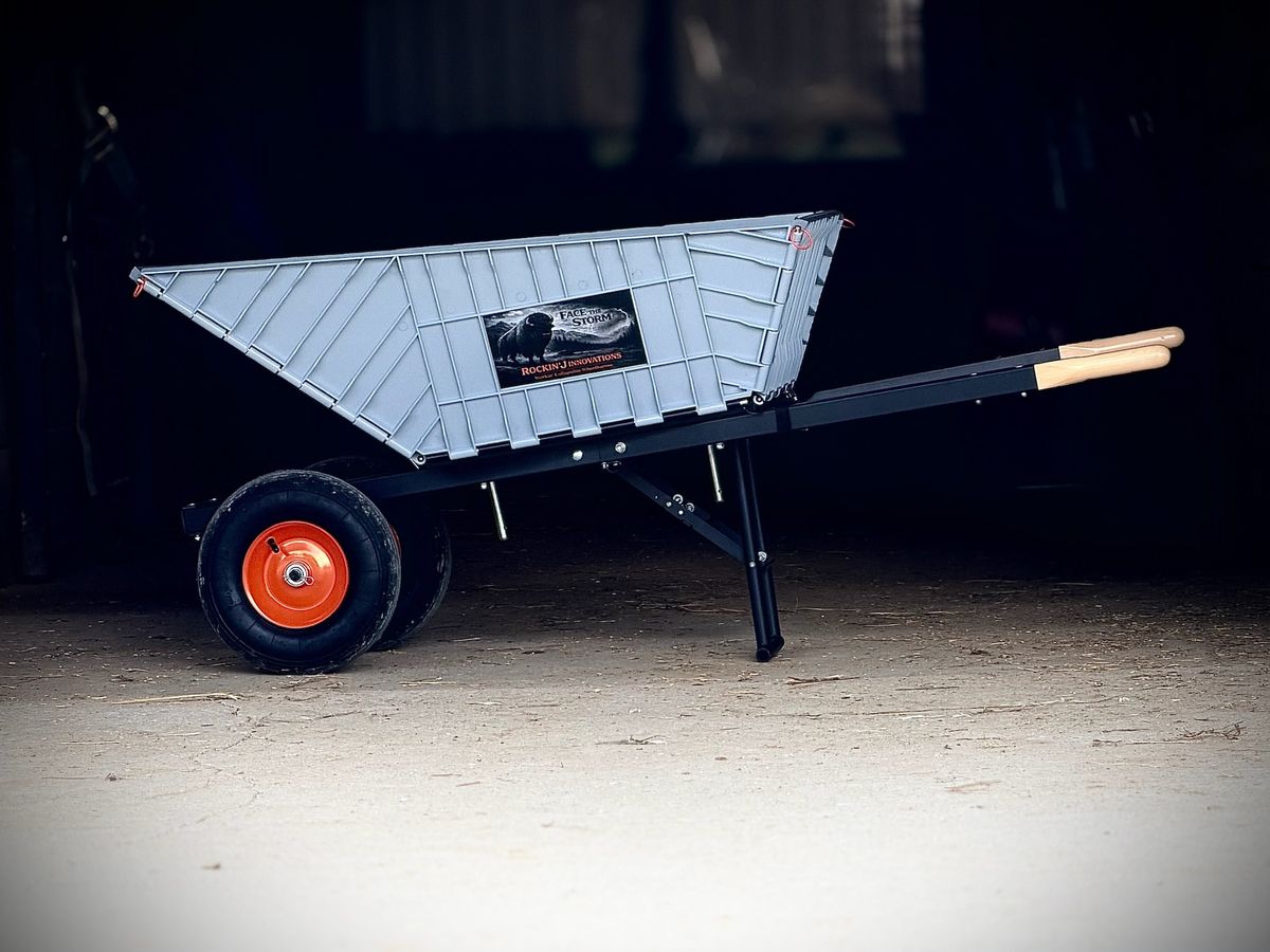 The Workin’ Collapsible Wheelbarrow in a barn doorway