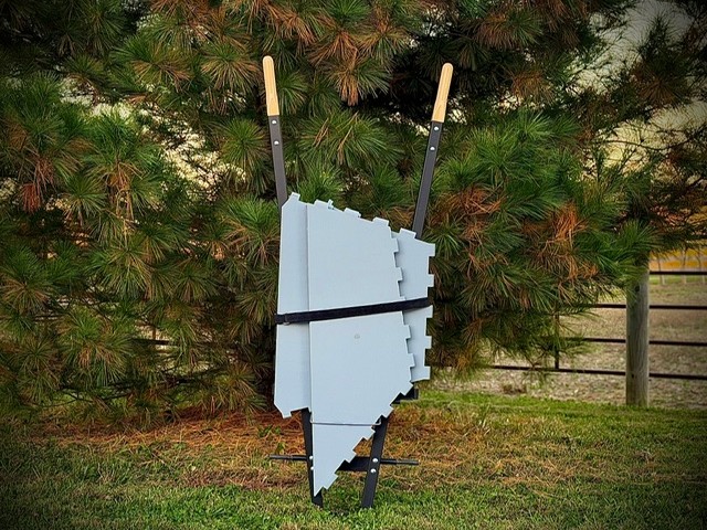 The wheelbarrow collapsed and stood on end, the tub panels strapped flat on the base