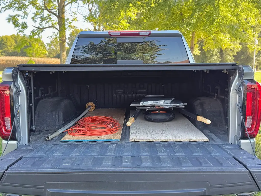 Collapsed and lying flat in a pickup bed with the tailgate down